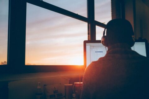 Man looking at the window with notebook